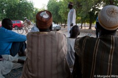 Diffa : un militaire en patrouille passe à côté d'un groupe d'hommes en discussion.